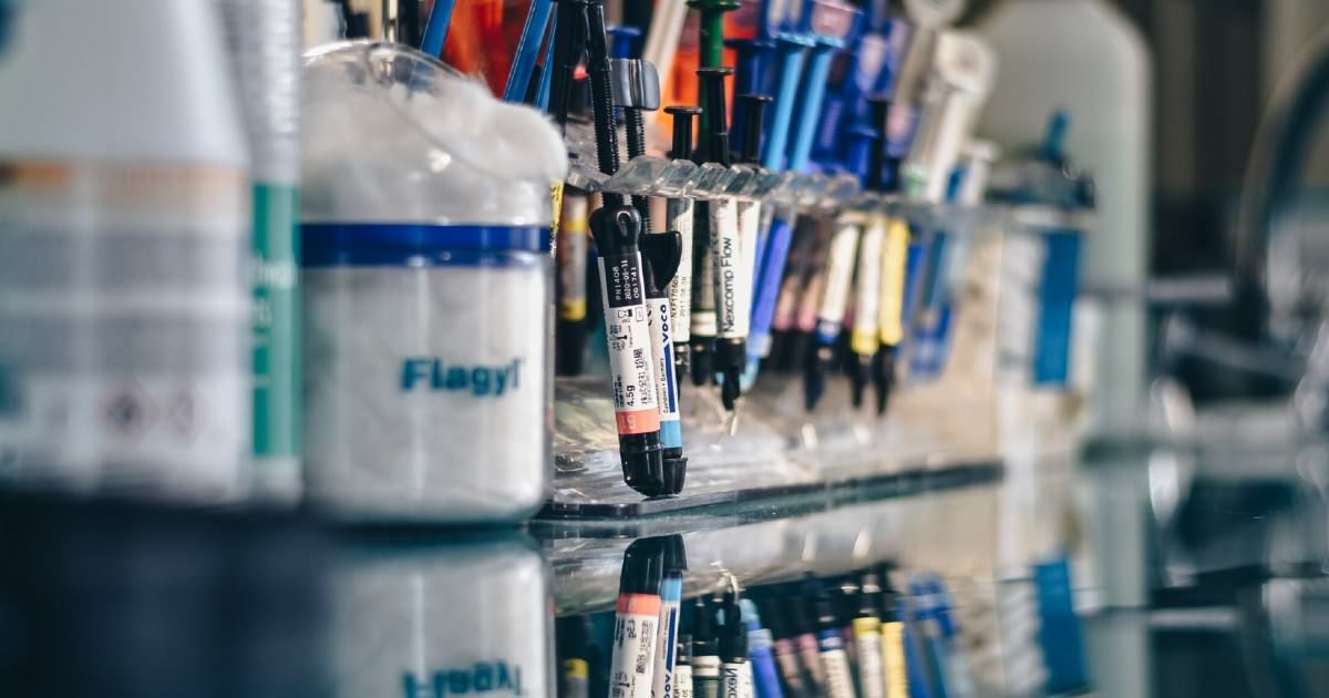 Tray of surgical supplies, including syringes and disposable materials, on a case cart in a hospital