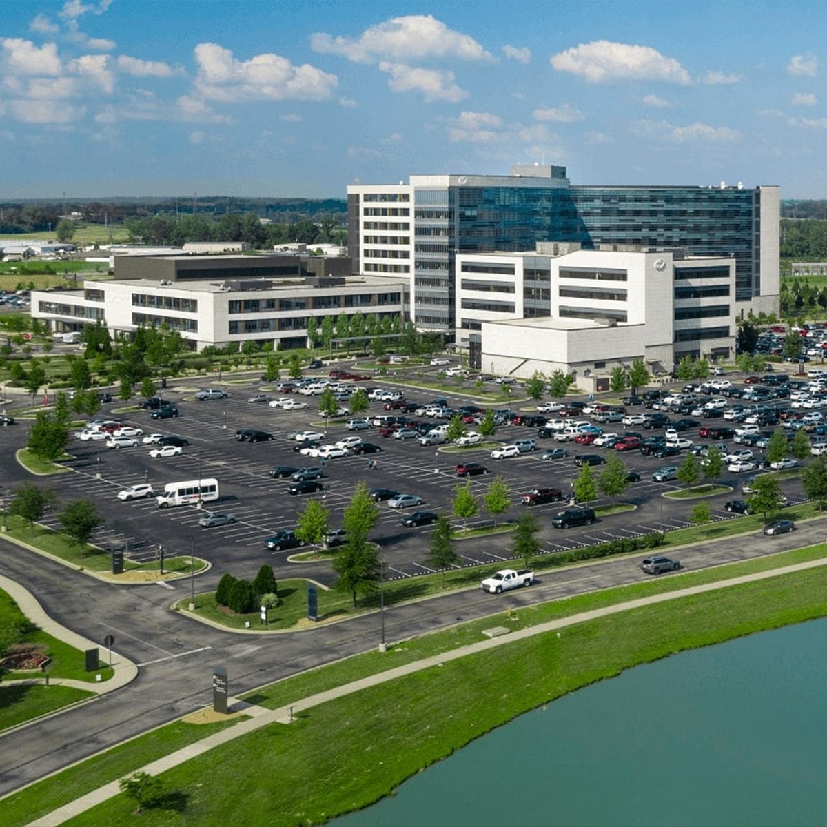 Aerial view of Owensboro Health's modern multi-building hospital campus with parking lots and a landscaped pond